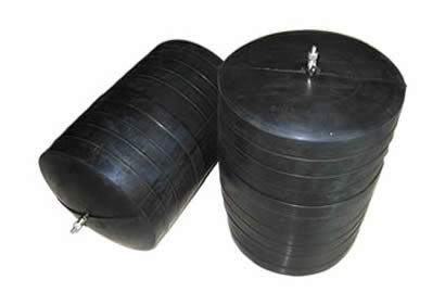 Two black blocking inflatable pipe plugs are placed on the ground.