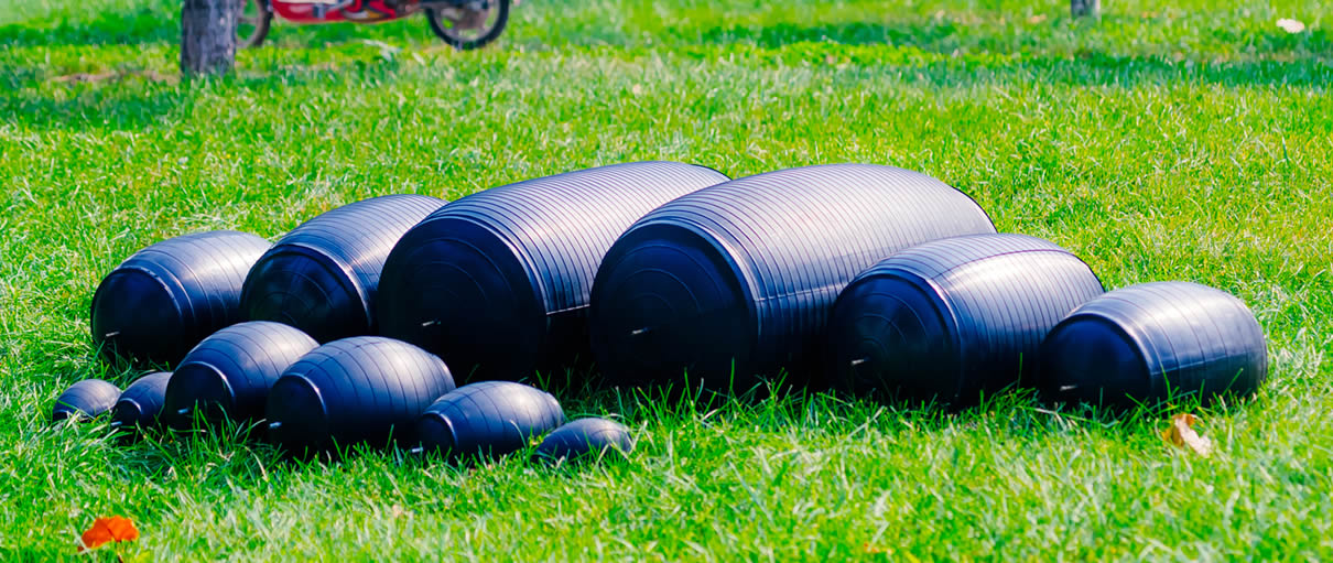 There are twelve inflatable pipe plugs on the grass, and they have different sizes.