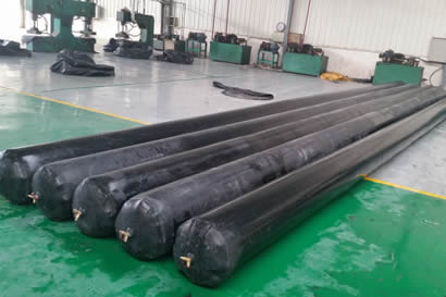 Five diameter unchanged round inflatable rubber mandrels are on the floor of the workshop.