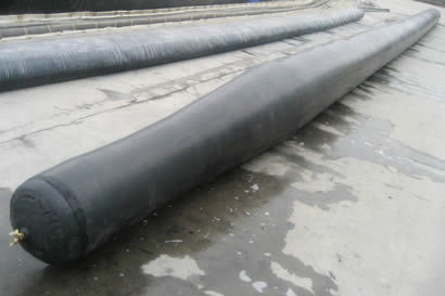 A black diameter variable round inflatable rubber mandrel is on the floor.