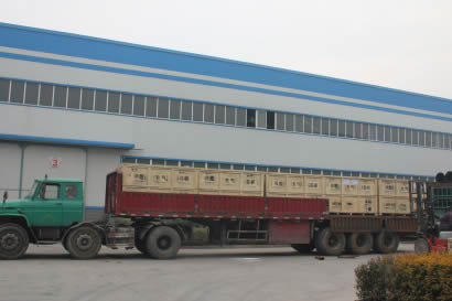 Some wooden boxes containing round inflatable rubber mandrels are on the truck.