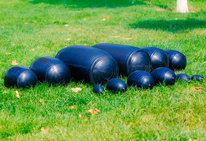 Different sizes inflatable pipe plugs on the grass.